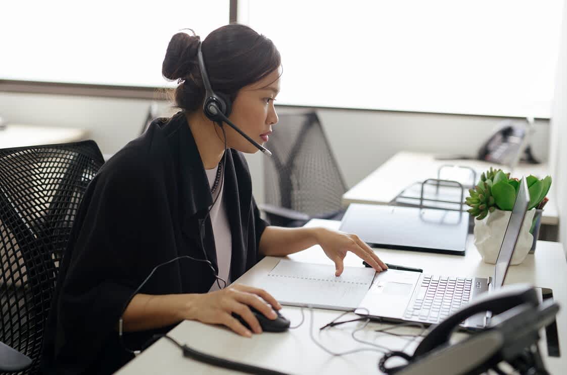 Female receptionist answer calls for a business