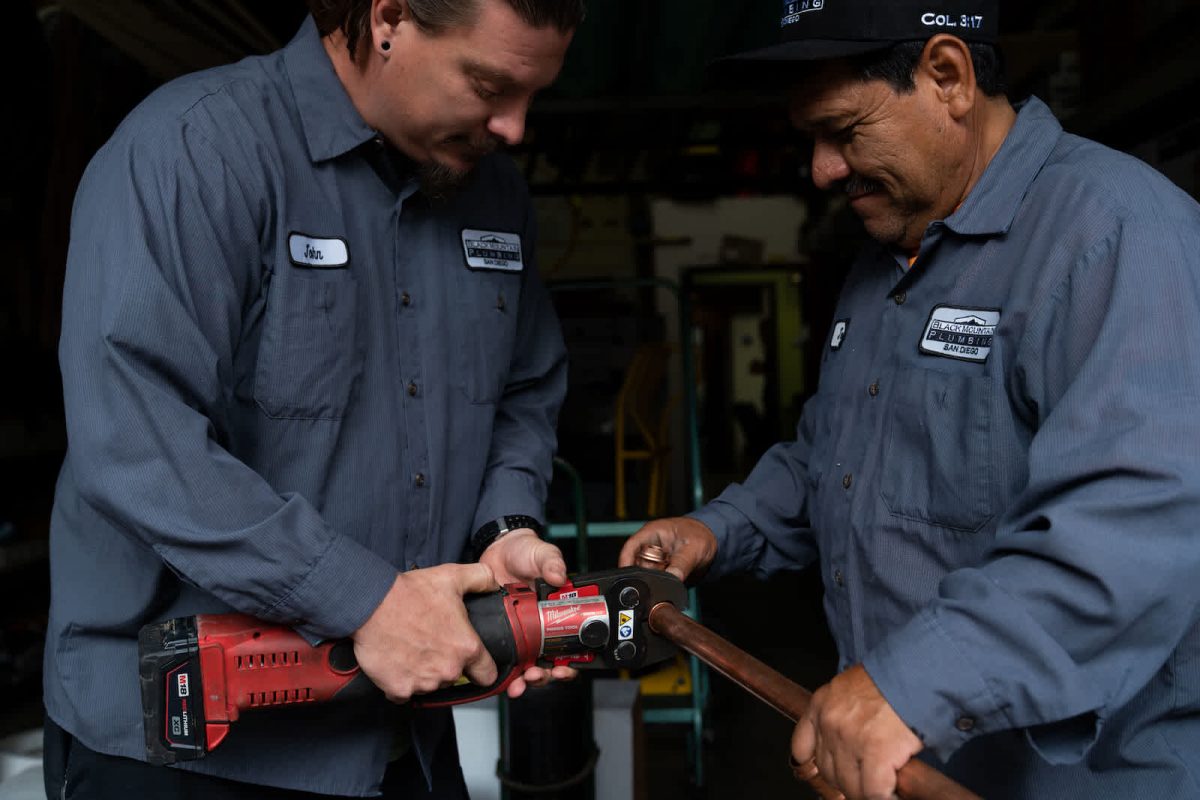 Two Plumbers Working on a pipe