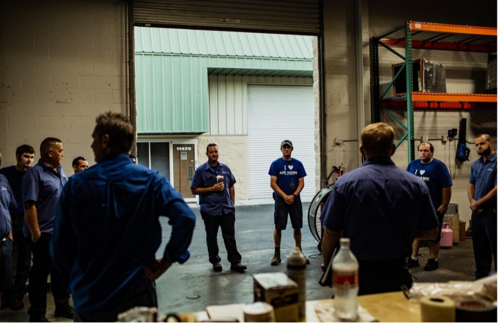 HVAC team in huddle at warehouse