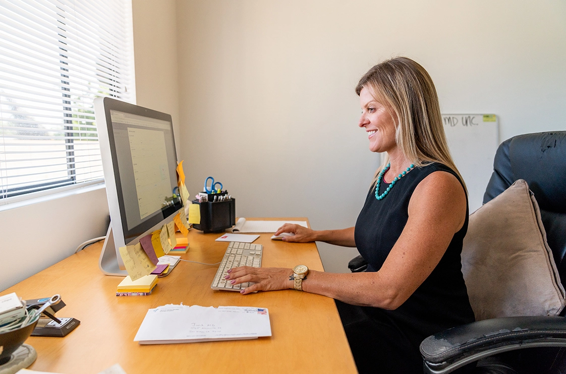 Female pro checks time tracking metrics on office desktop